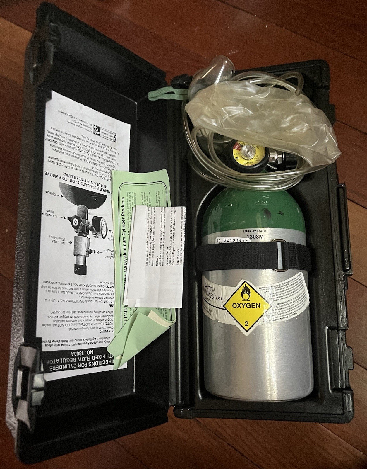 Mada portable emergency oxygen unit, model 1303M housed in a black plastic case.